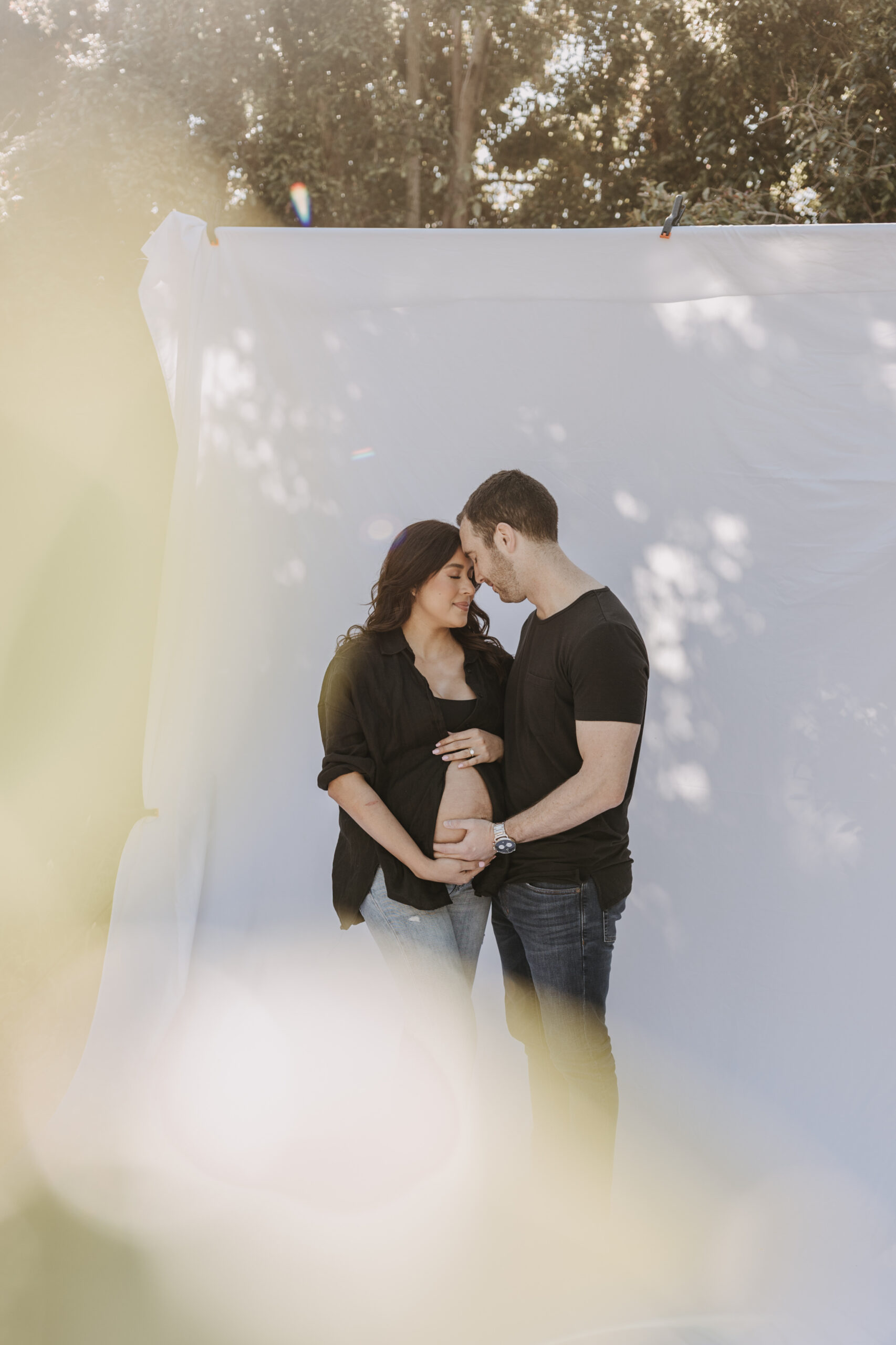 backyard mini maternity session maternity photos white backdrop sabrinalynnphoto San Diego couples photographer florals