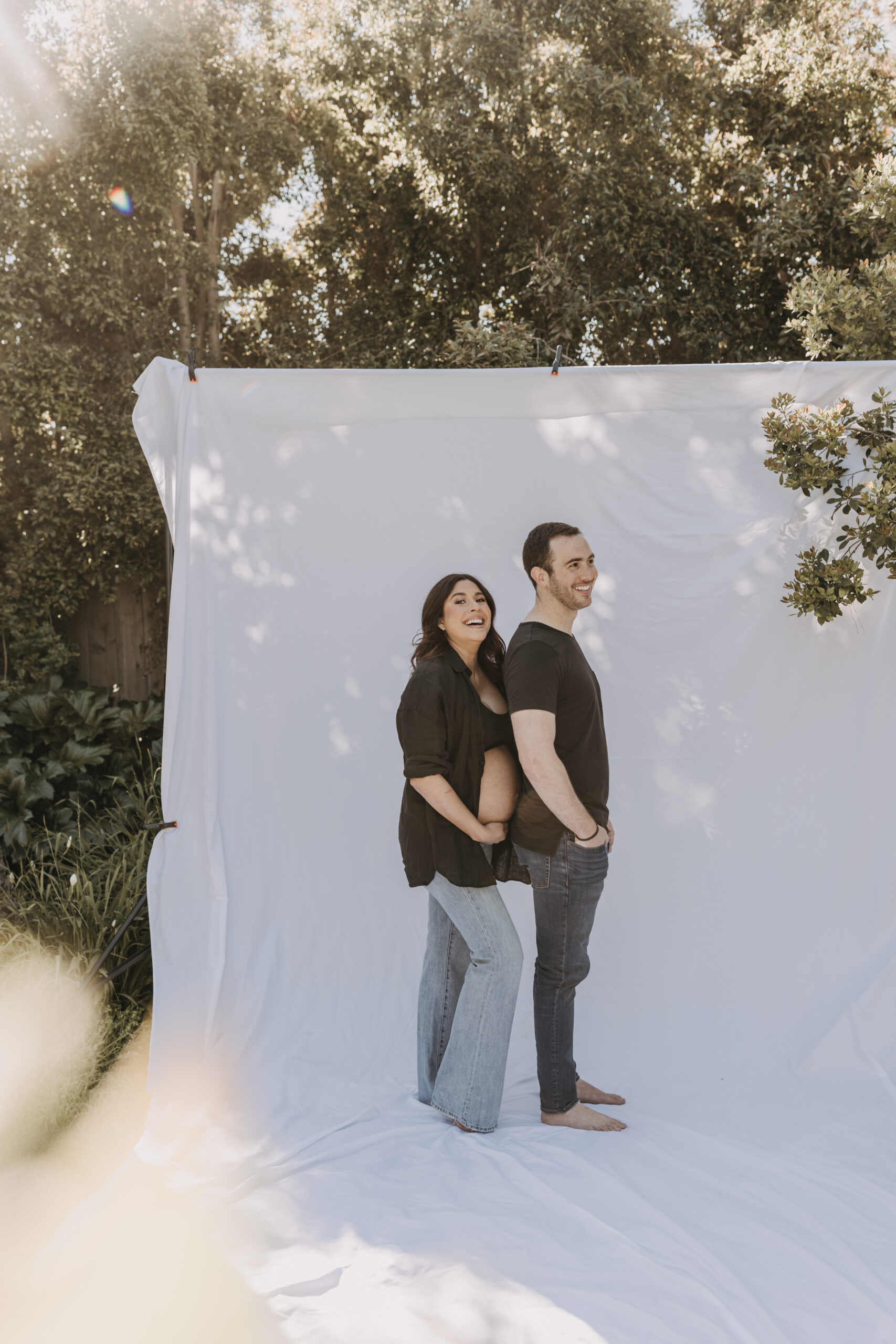 backyard mini maternity session maternity photos white backdrop sabrinalynnphoto San Diego couples photographer florals