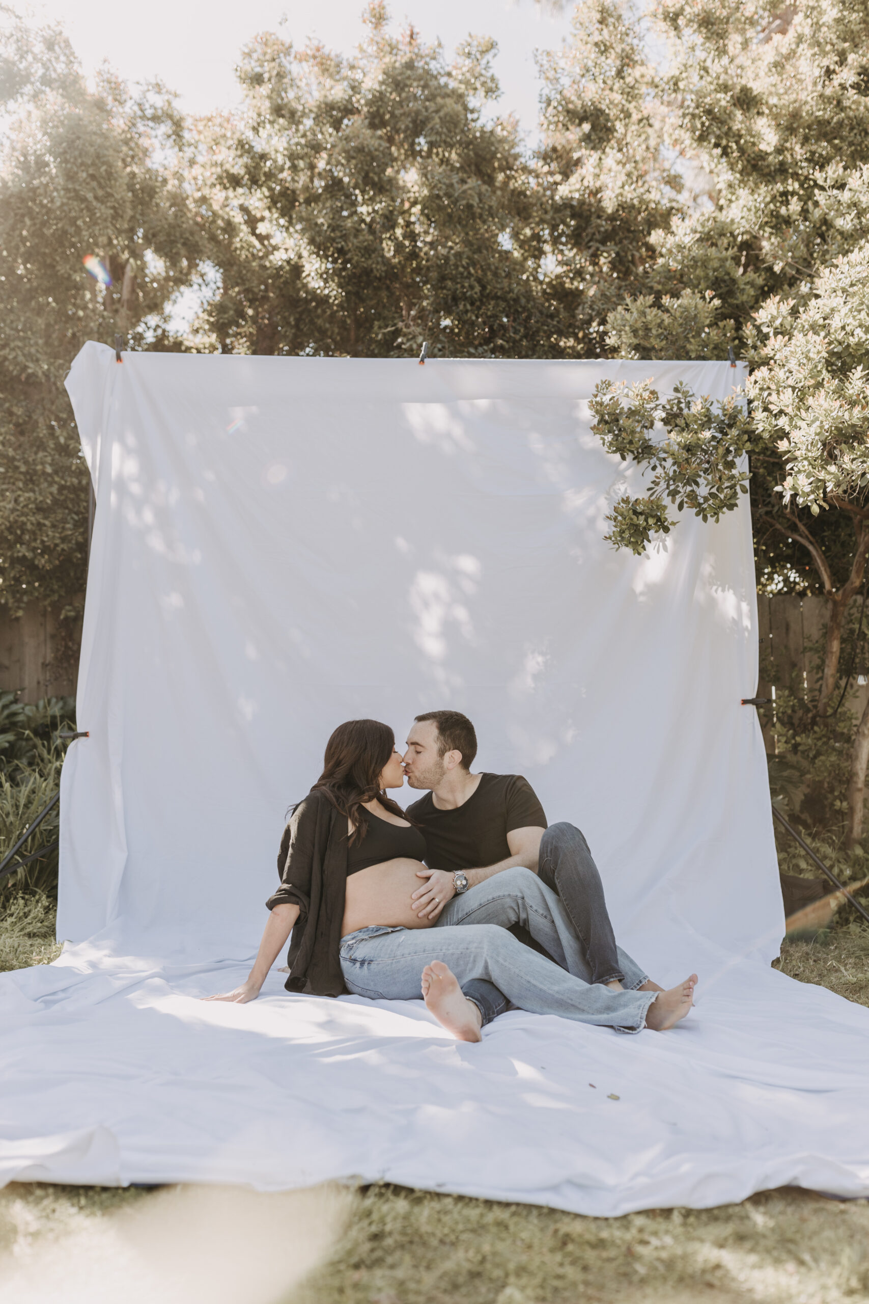 backyard mini maternity session maternity photos white backdrop sabrinalynnphoto San Diego couples photographer florals