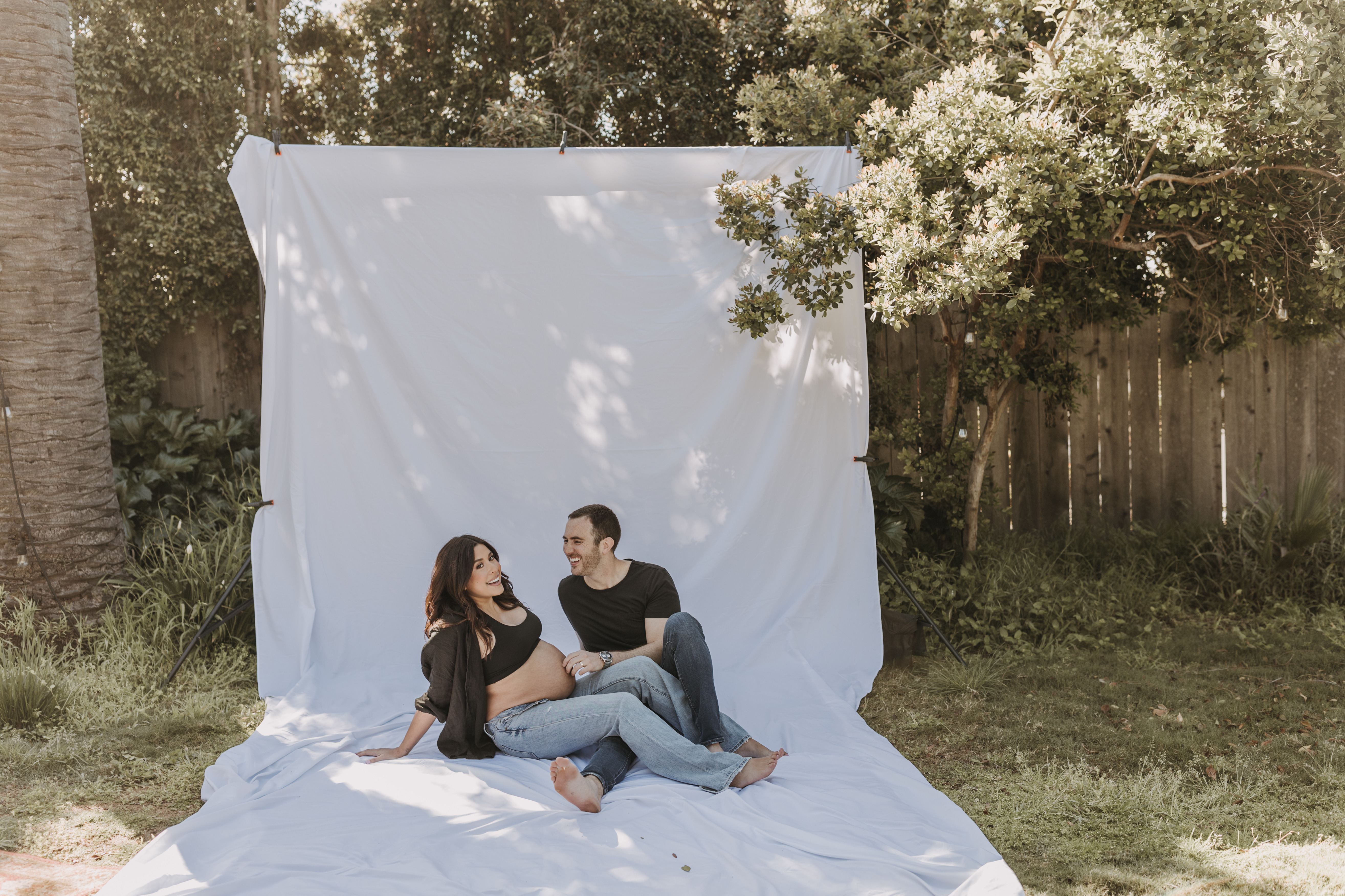 backyard mini maternity session maternity photos white backdrop sabrinalynnphoto San Diego couples photographer florals 