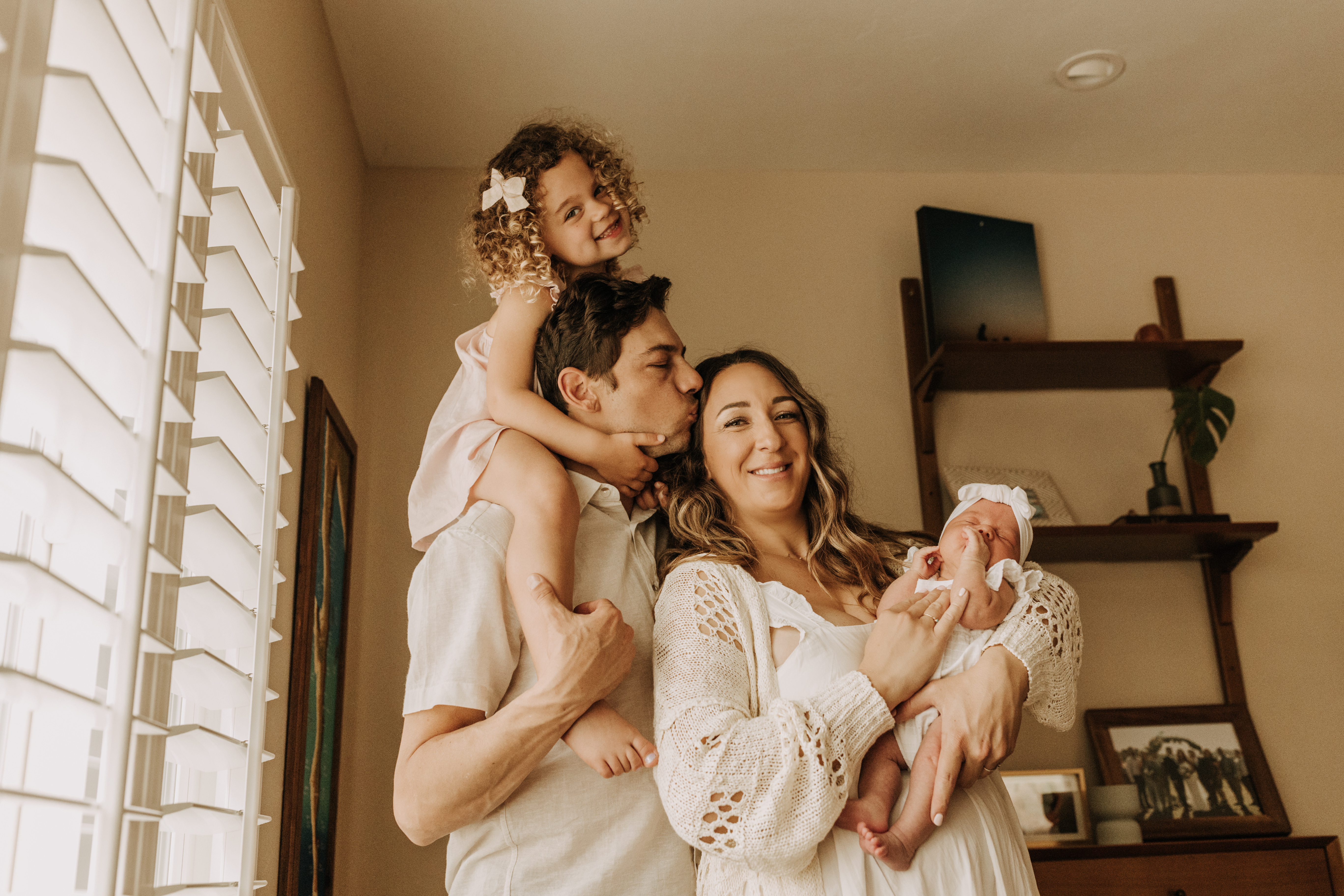 warm and cozy in home family session newborn photos newborn baby infant photos candid family moments neutral toned in home family of four San Diego family photographer Sabrina kinsella sabrinalynnphoto