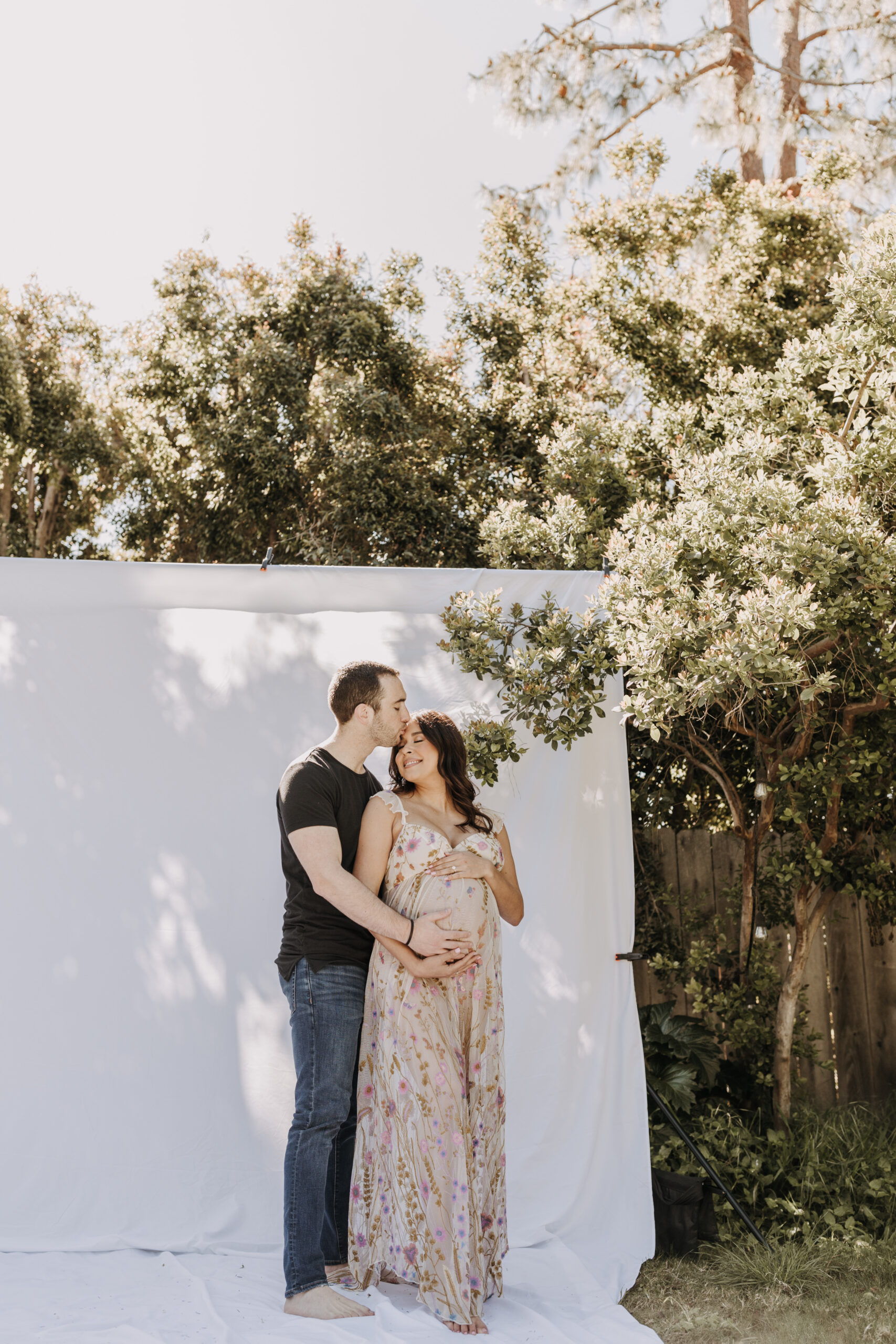 backyard mini maternity session maternity photos white backdrop sabrinalynnphoto San Diego couples photographer florals