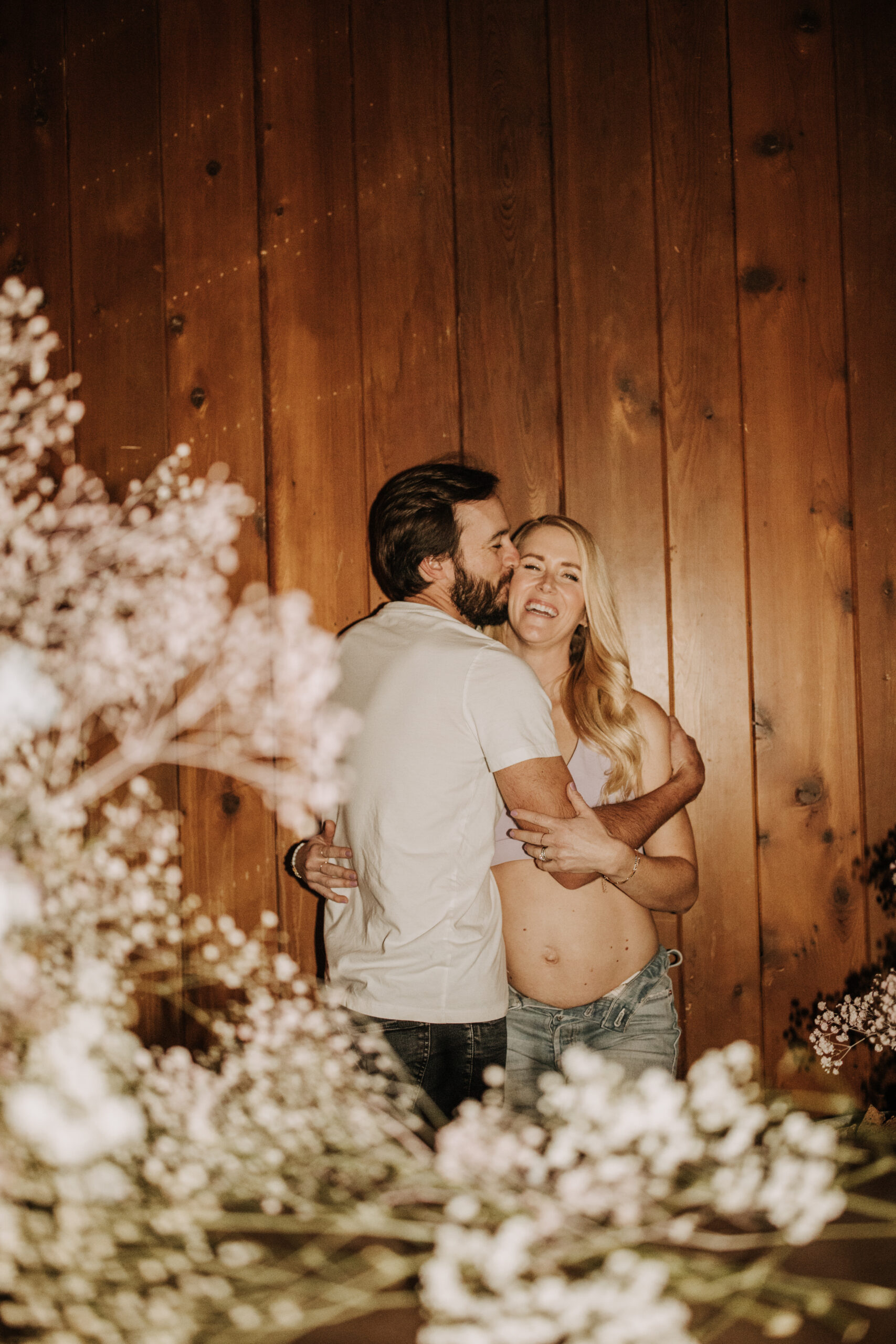 in home San Diego maternity photos raw real family photos gender reveal photos with flowers babies breath pink and blue boy or girl reveal ultrasound pregnancy photos San Diego maternity photographer Sabrina kinsella sabrinalynn photo