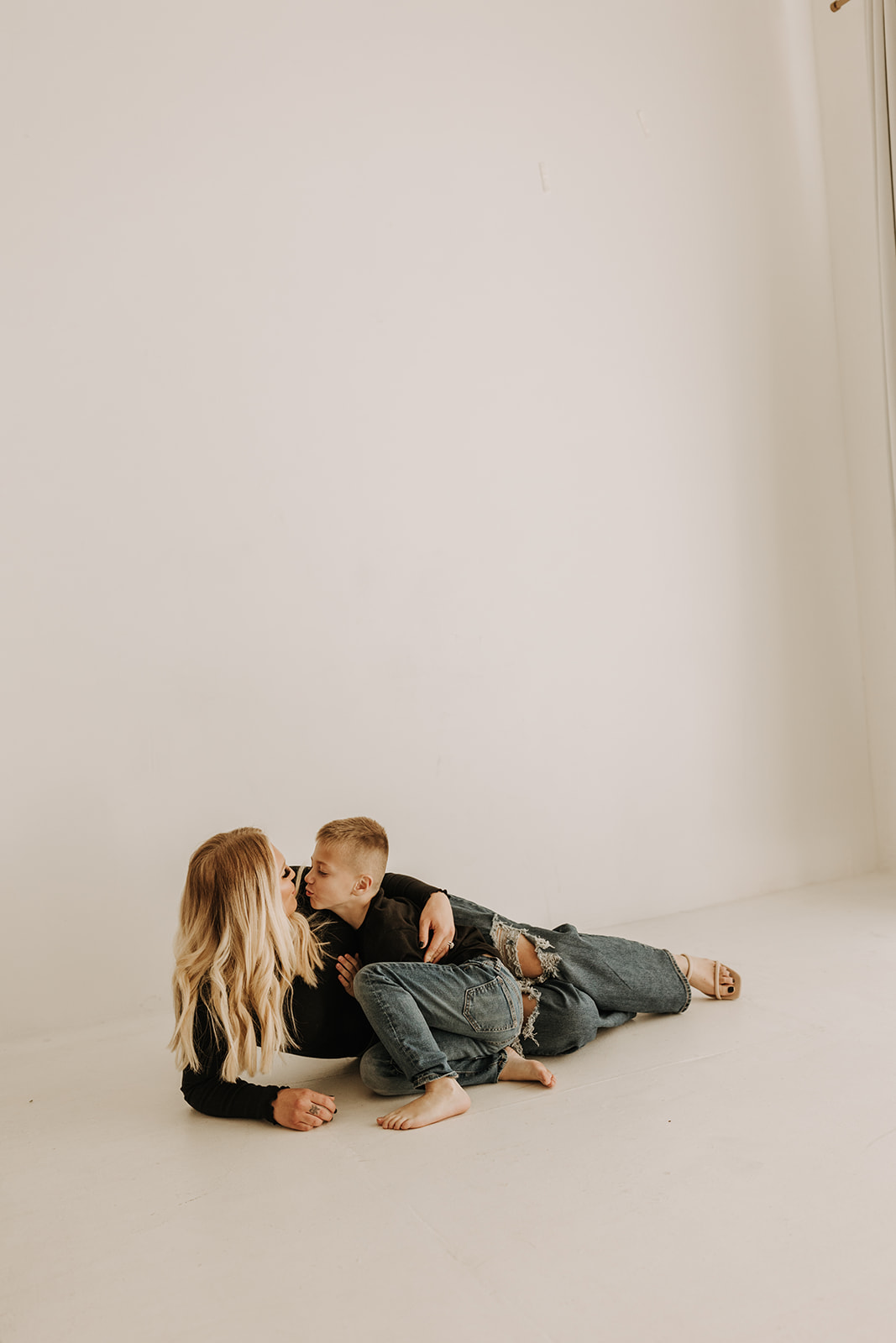 family session warm candid family photos motherhood moments mommy and me studio session neutral gallery San Diego family photographer Sabrina kinsella mom of two boys