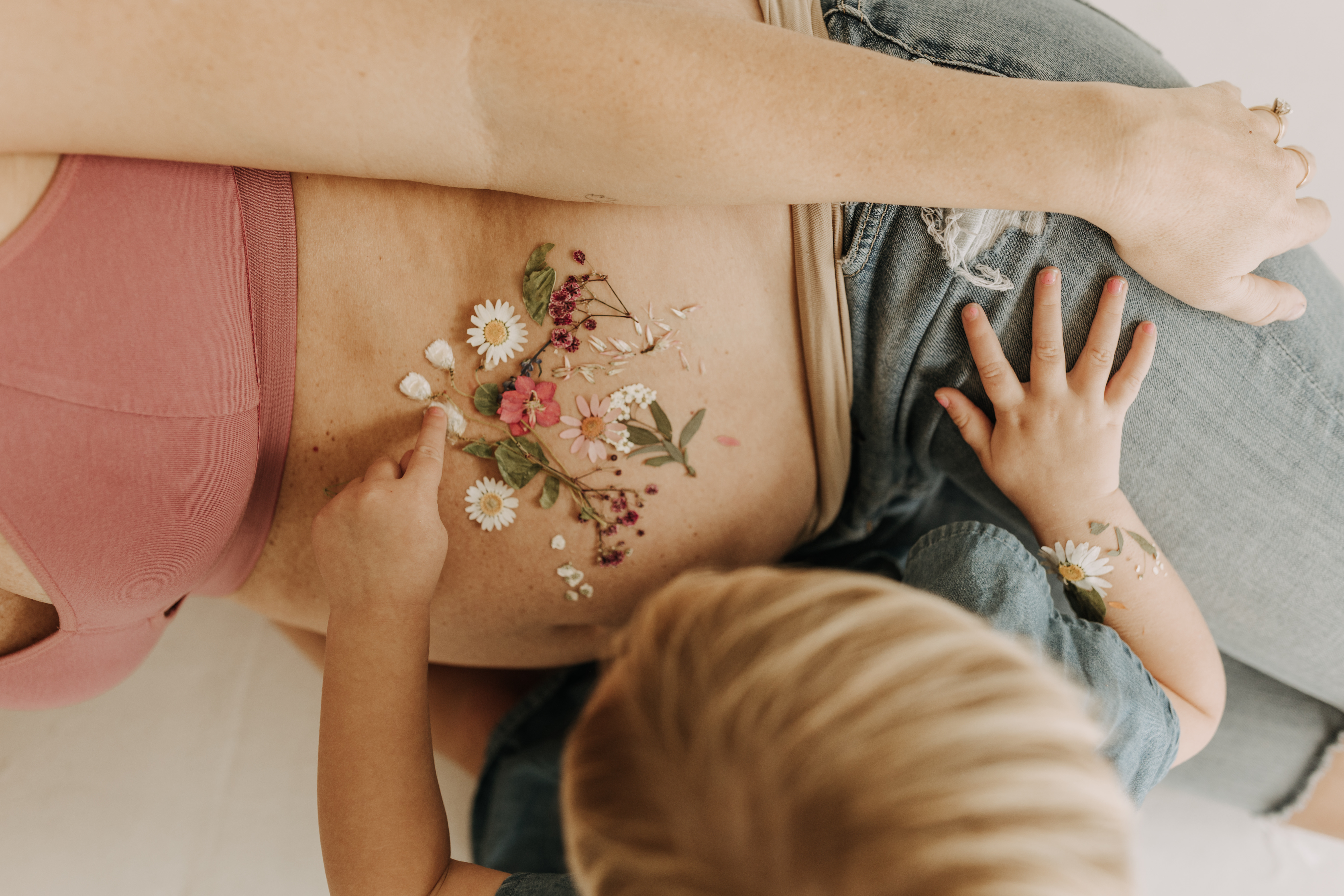 studio photography session pink maternity photos in a studio white backdrop pink confetti streamers mama and me motherhood mini sessions family photos candid maternity photos styled shoot San Diego maternity photographer Sabrinalynnphoto Sabrina kinsella 