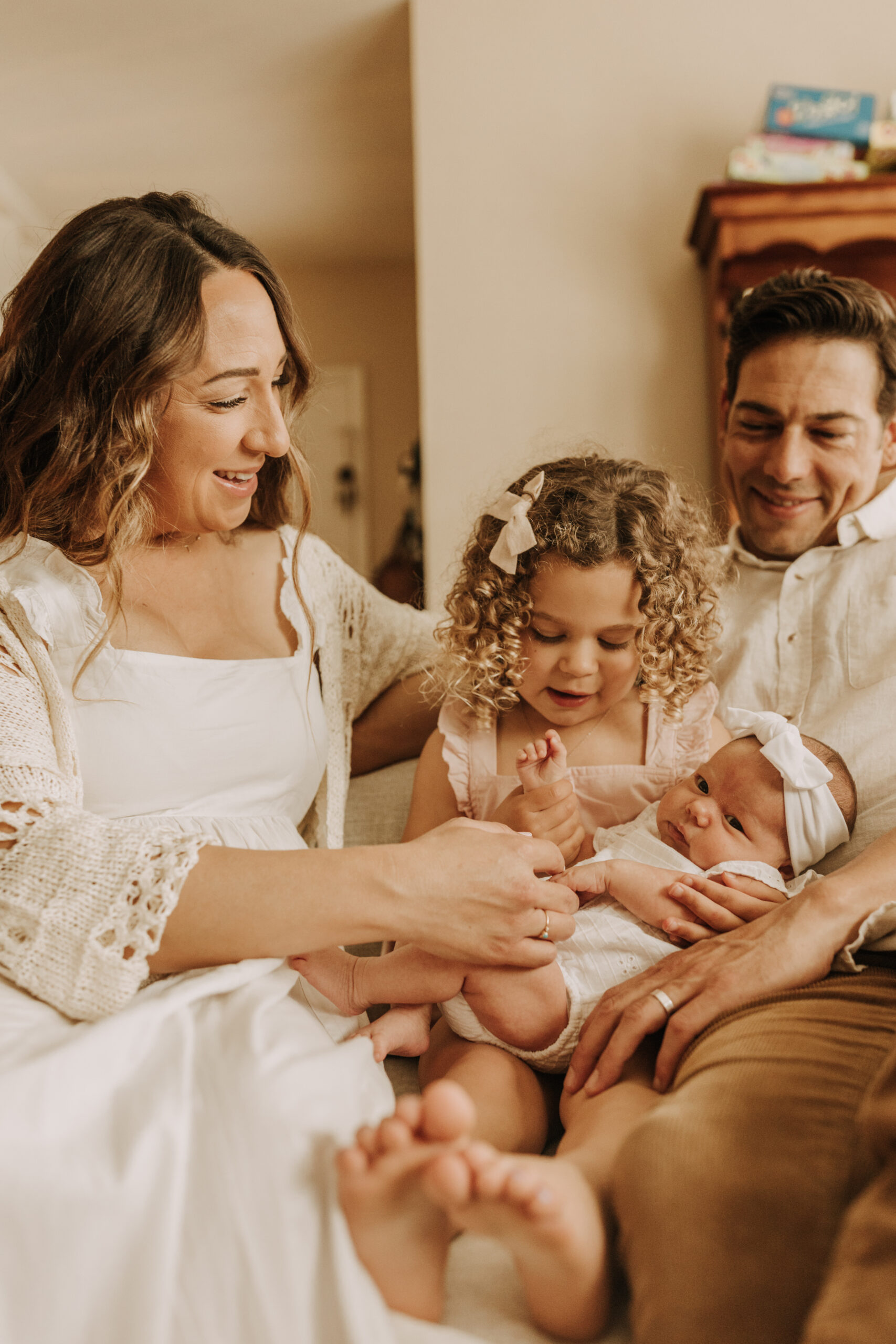 warm and cozy in home family session newborn photos newborn baby infant photos candid family moments neutral toned in home family of four San Diego family photographer Sabrina kinsella sabrinalynnphoto