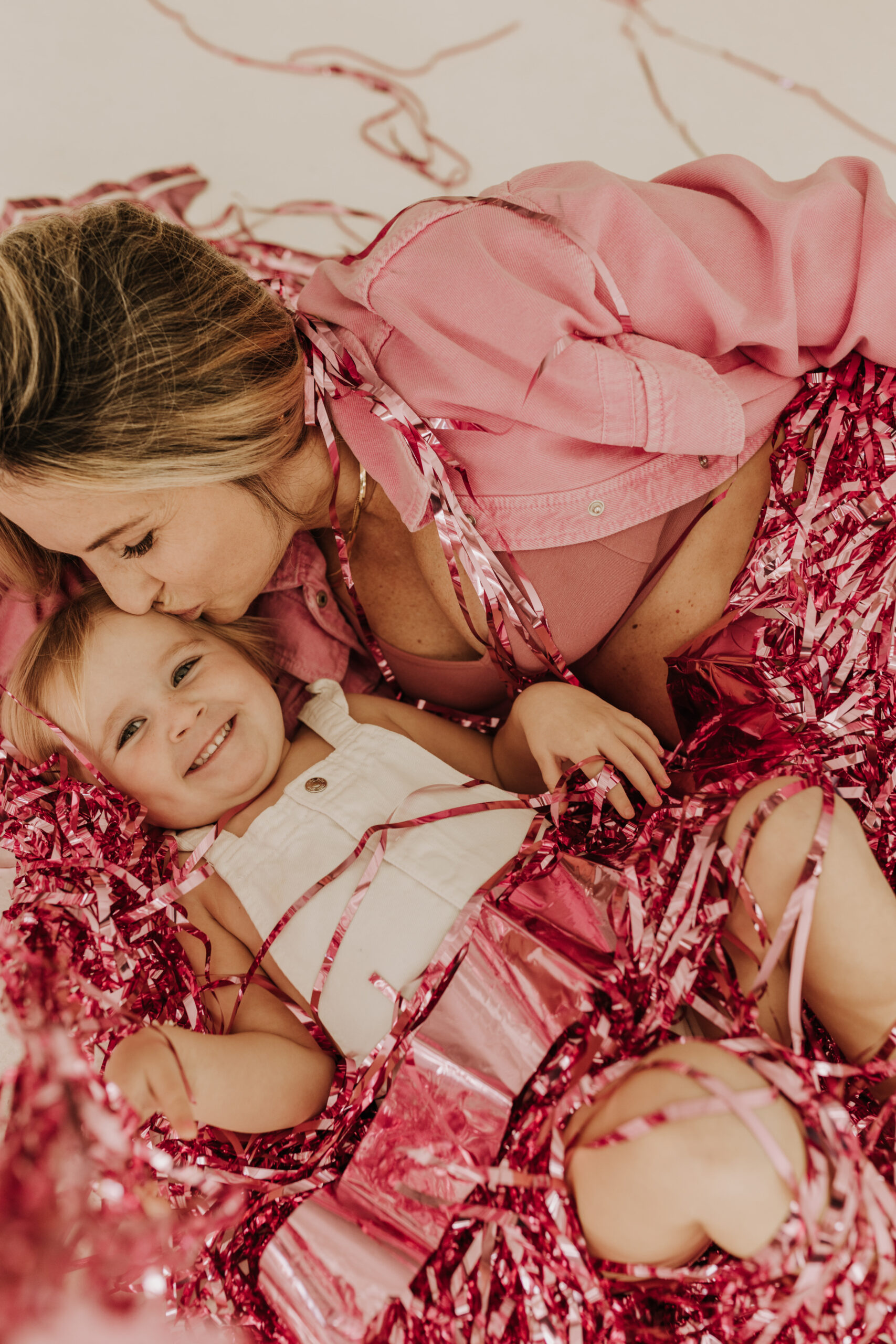 studio photography session pink maternity photos in a studio white backdrop pink confetti streamers mama and me motherhood mini sessions family photos candid maternity photos styled shoot San Diego maternity photographer Sabrinalynnphoto Sabrina kinsella