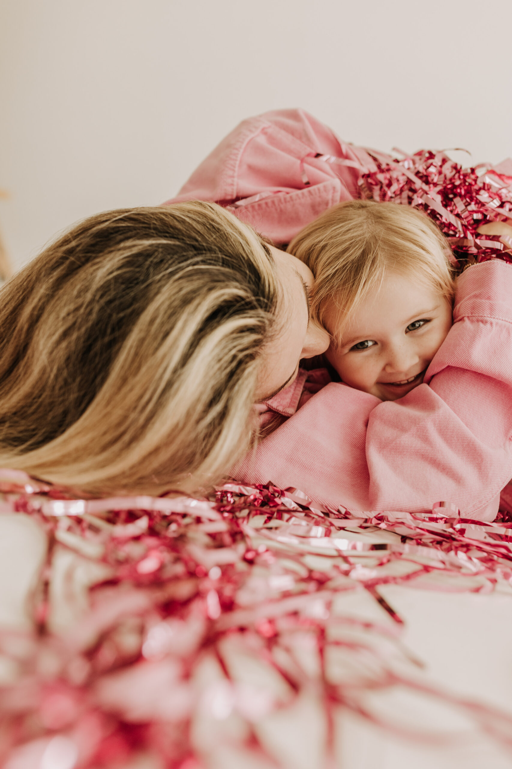 studio photography session pink maternity photos in a studio white backdrop pink confetti streamers mama and me motherhood mini sessions family photos candid maternity photos styled shoot San Diego maternity photographer Sabrinalynnphoto Sabrina kinsella