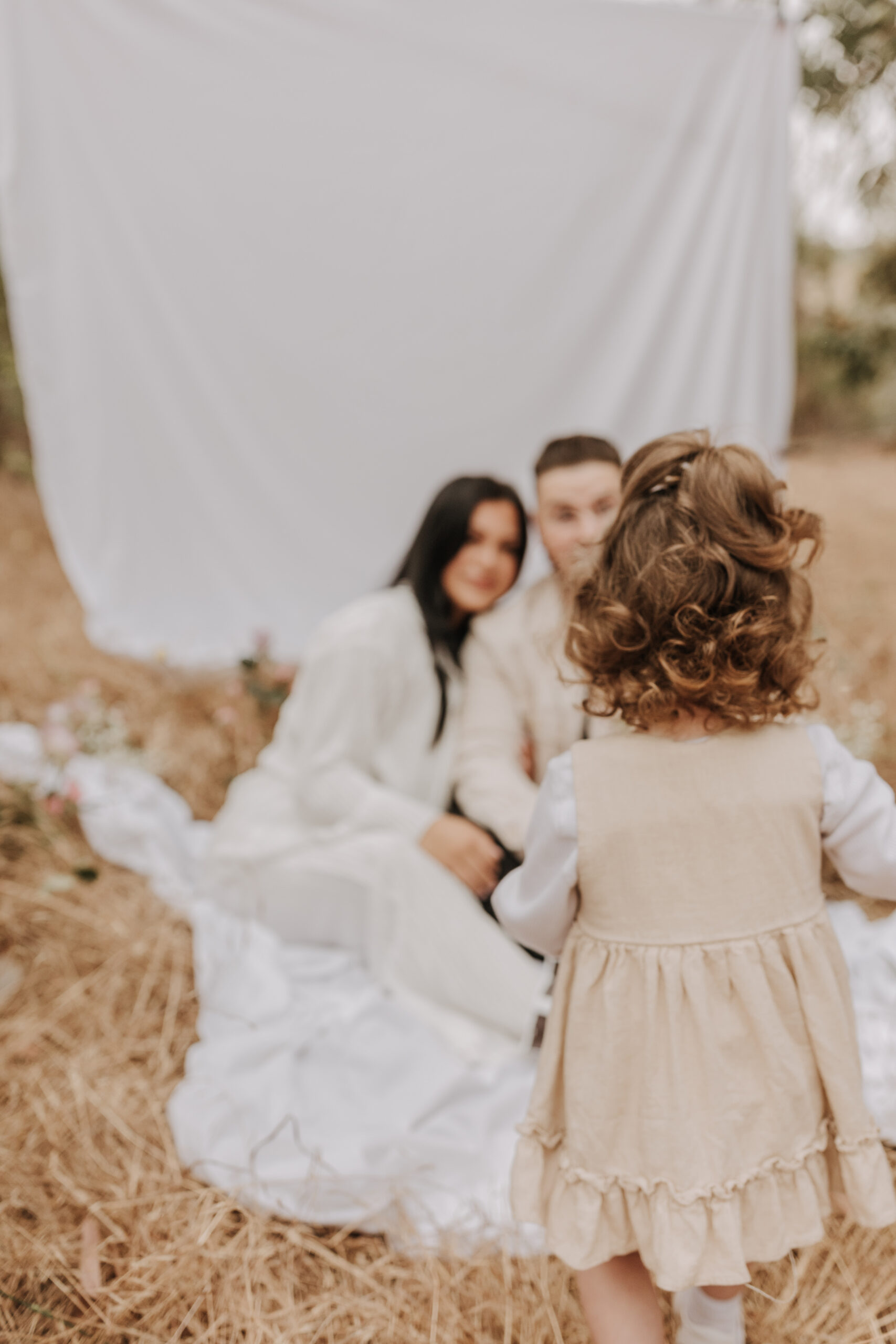 backyard mini maternity styled shoot San Diego family photographer neutral toned maternity photos candid outdoor family photos