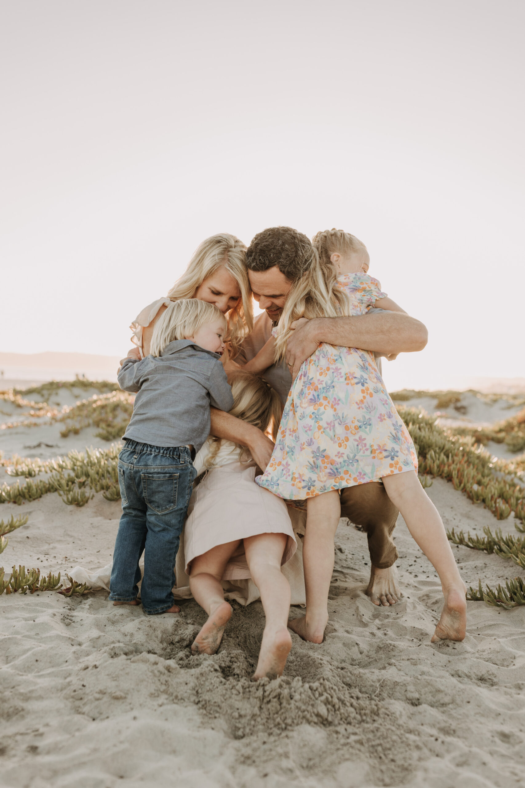 beach family photos sunset golden hour candid family photos family of four at sunset on the beach san Diego family photographer Sabrina kinsella sabrinalynnphoto