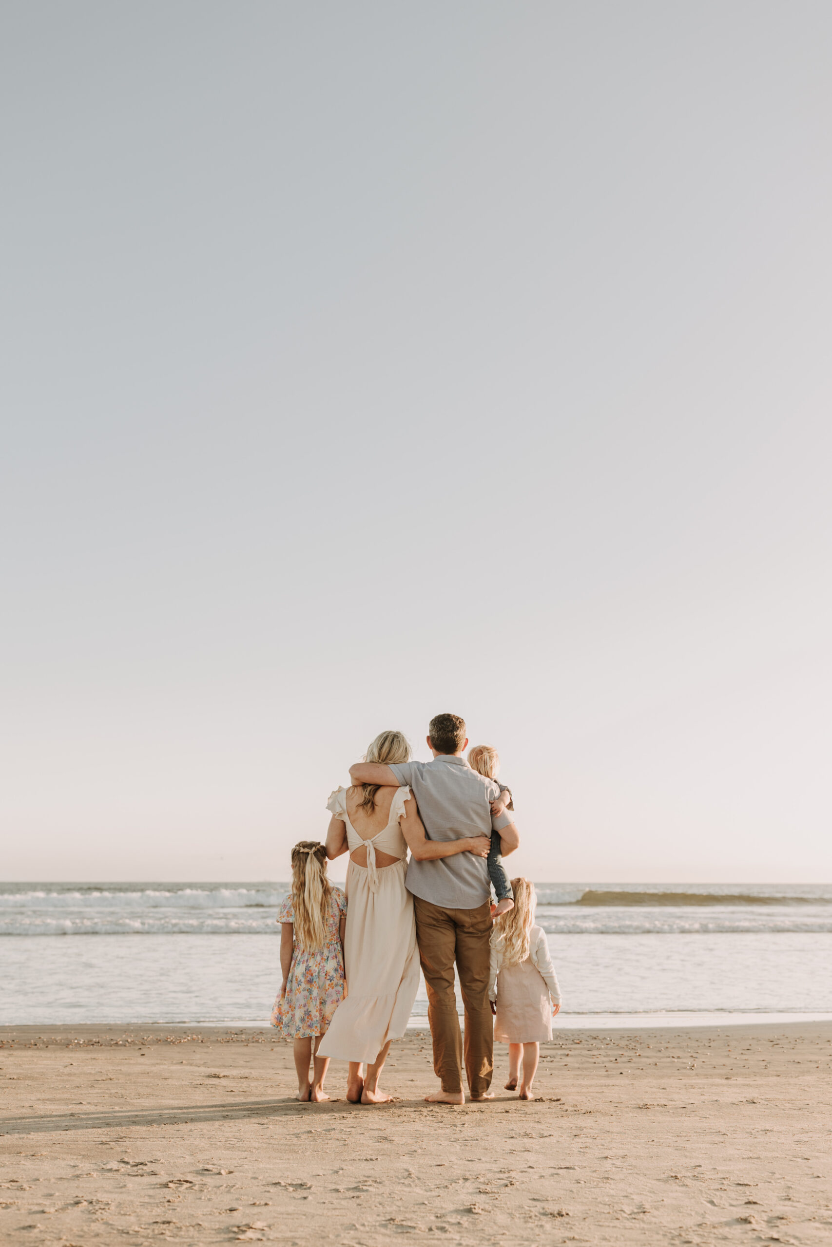 beach family photos sunset golden hour candid family photos family of four at sunset on the beach san Diego family photographer Sabrina kinsella sabrinalynnphoto