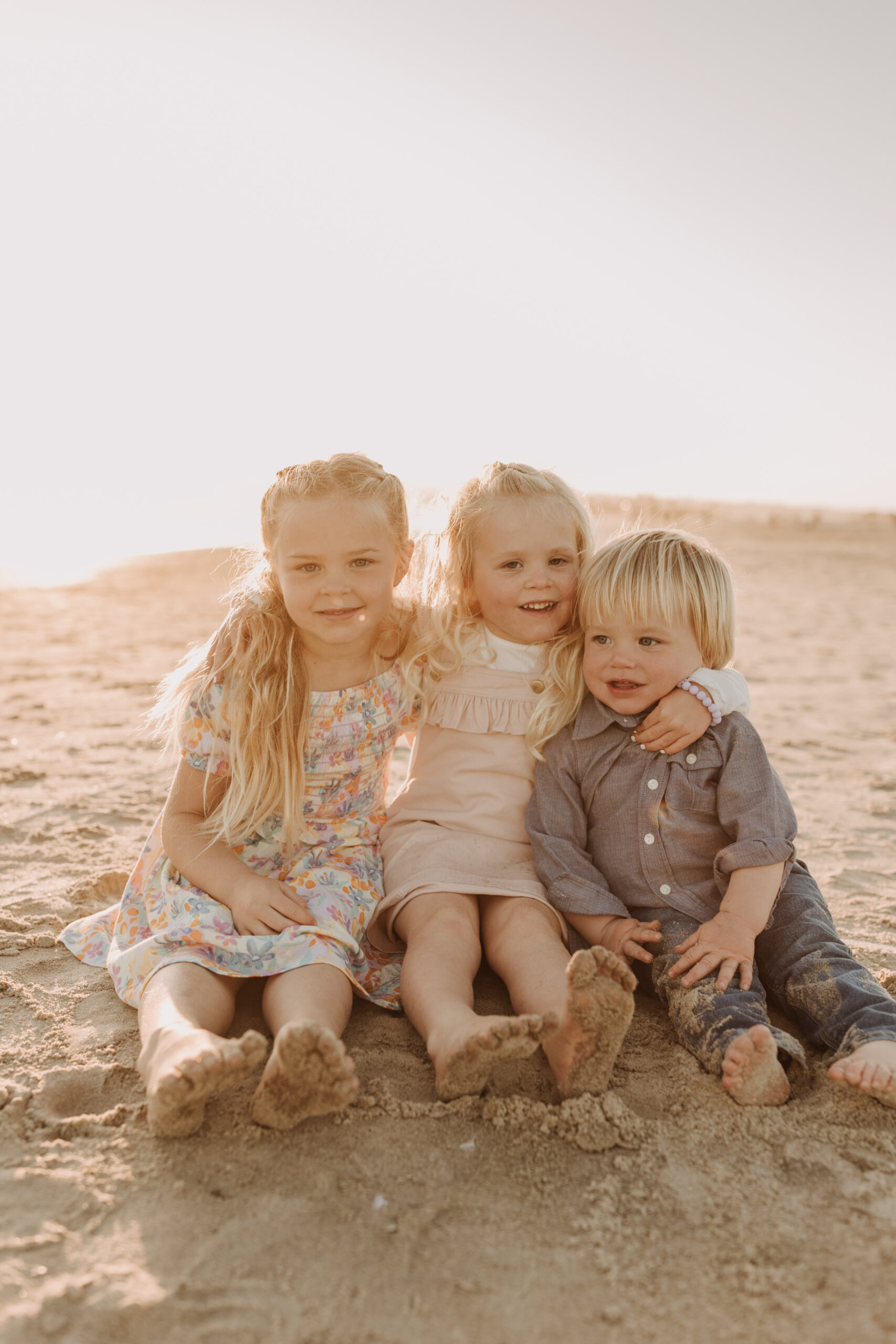 beach family photos sunset golden hour candid family photos family of four at sunset on the beach san Diego family photographer Sabrina kinsella sabrinalynnphoto