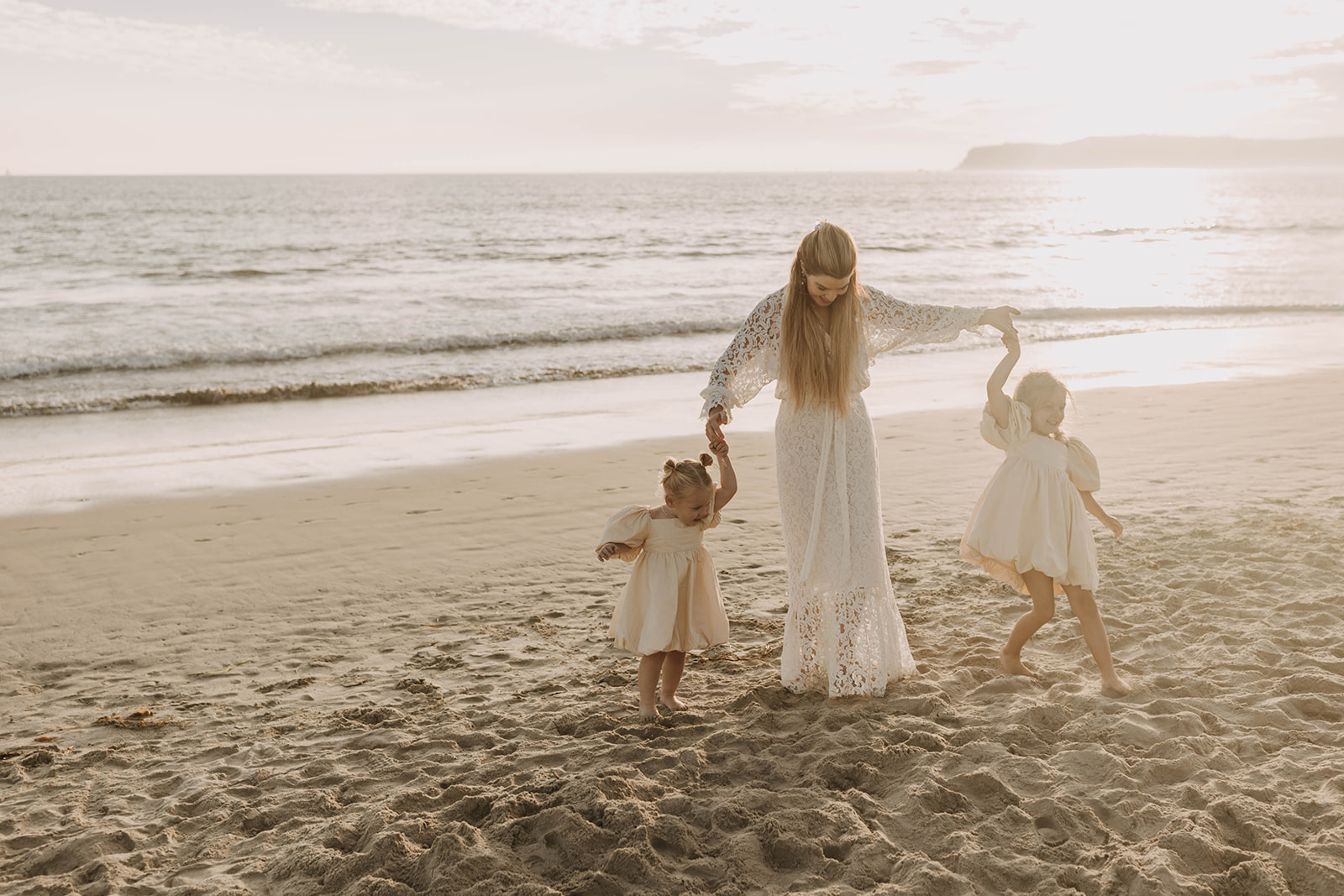 family photos at the beach with little ones at golden hour